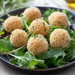 Couscousbällchen mit Feta und Sesam auf Feldsalat First Image First Image